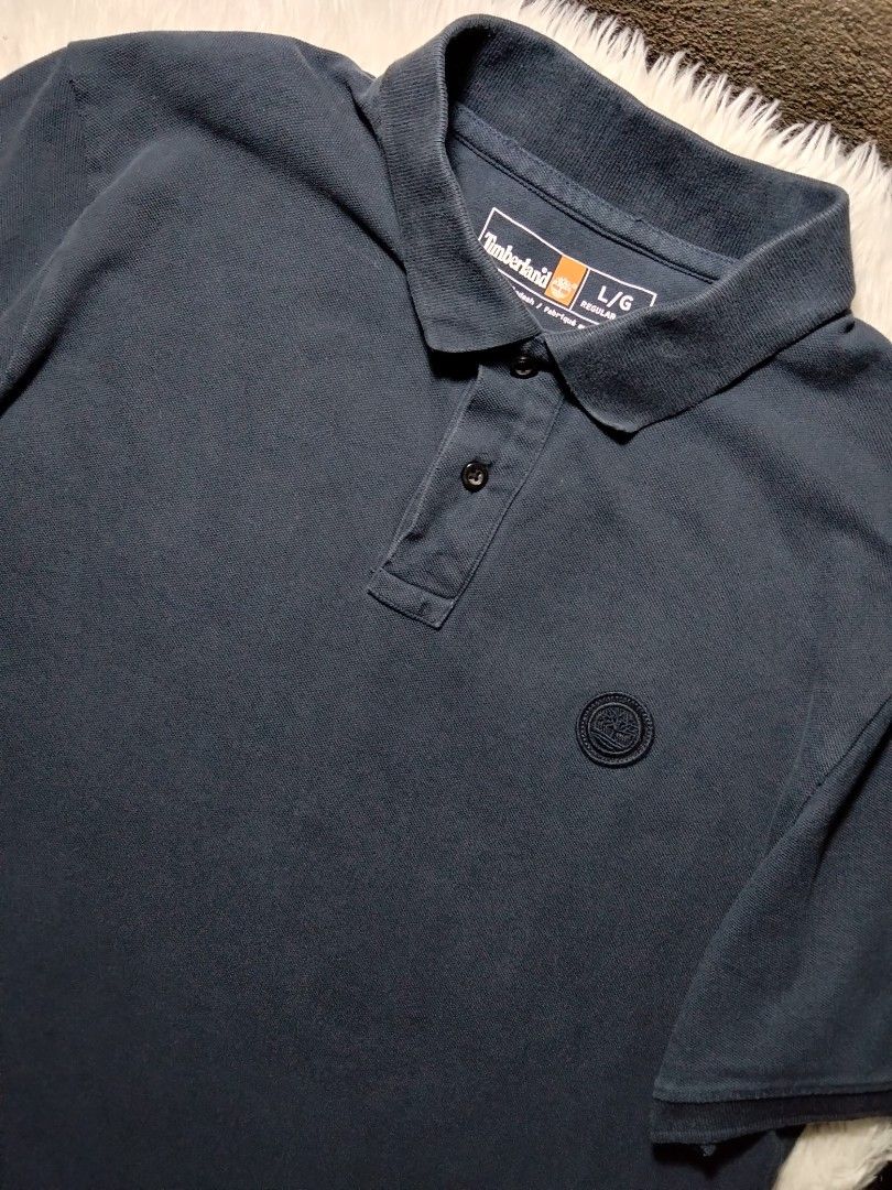 Timberland dark navy blue poloshirt (Category: Tshirts & Polo Shirts ) located in Arakan. Submitted by thrift_ala_king (Listing ID 1448299255, Image 1). Description: ukay source lightly use 23x27.5 size L best fit M-L not washed has washable dust/dirt stains crispy condition no significant issue 250+sf.