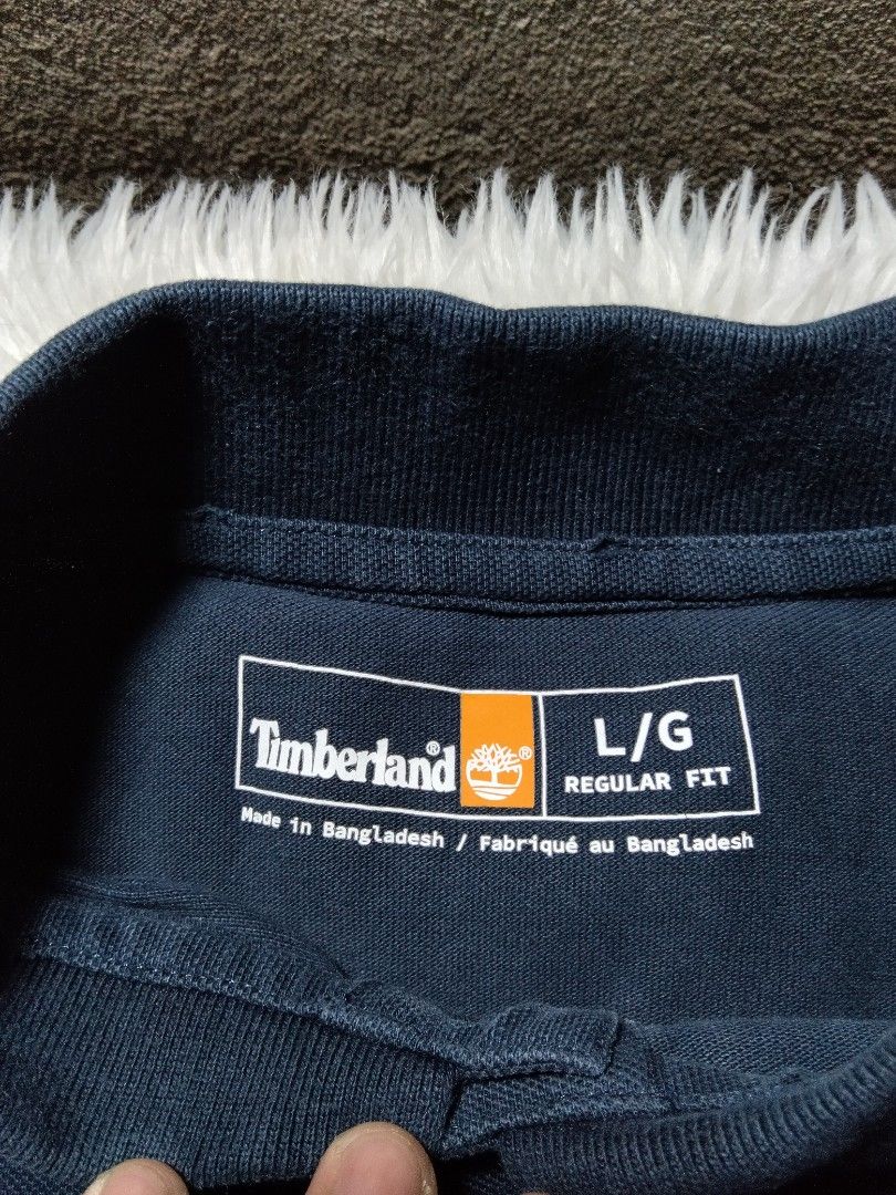 Timberland dark navy blue poloshirt (Category: Tshirts & Polo Shirts ) located in Arakan. Submitted by thrift_ala_king (Listing ID 1448299255, Image 3). Description: ukay source lightly use 23x27.5 size L best fit M-L not washed has washable dust/dirt stains crispy condition no significant issue 250+sf.