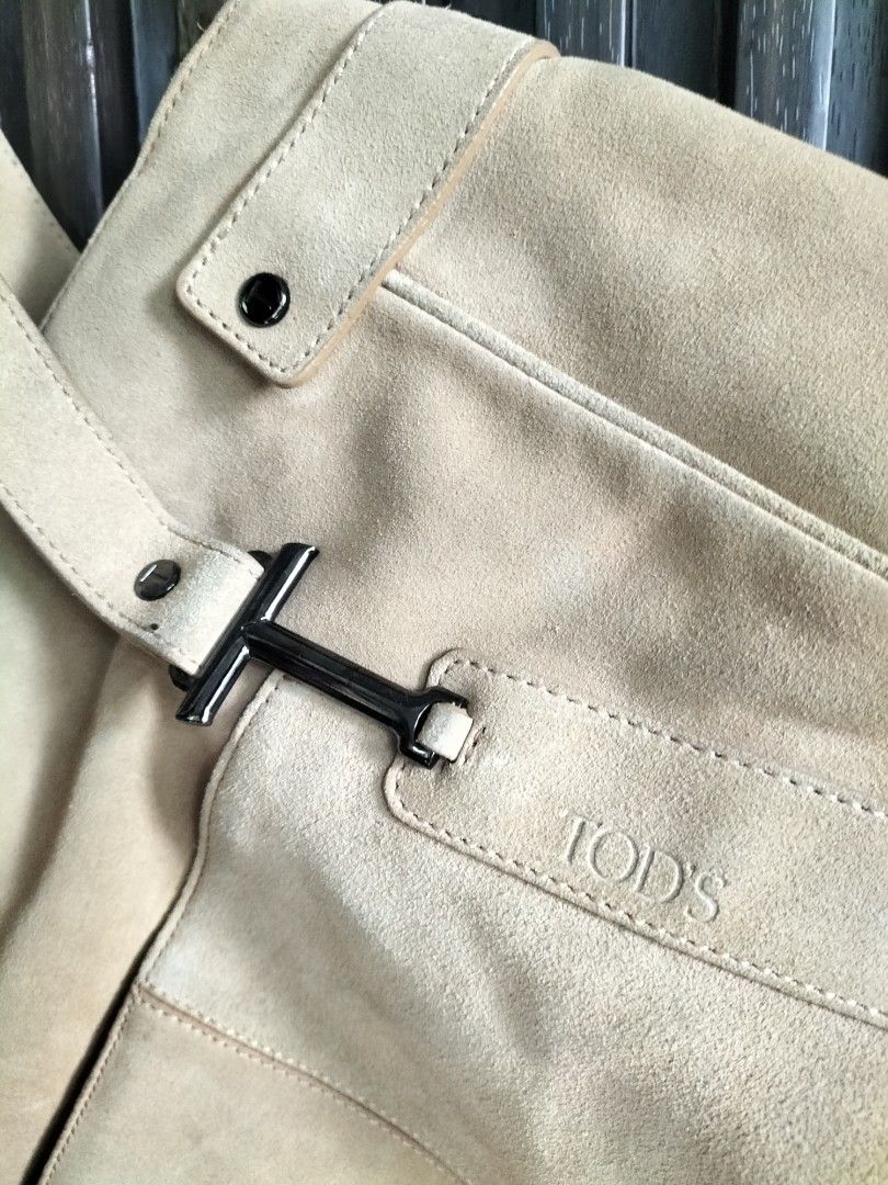 TOD'S Suede Tote Bag (Category: Luxury Bags & Wallets) located in Manila. Submitted by charms.krystal (Listing ID 1448349025, Image 2). Description: - Brand: TOD'S - Material: Light brown suede - Closure: Zip main compartment - Exterior: Front pocket with metal buckle detail - Straps: Comfortable for carrying - Style: Great everyday tote bag.
