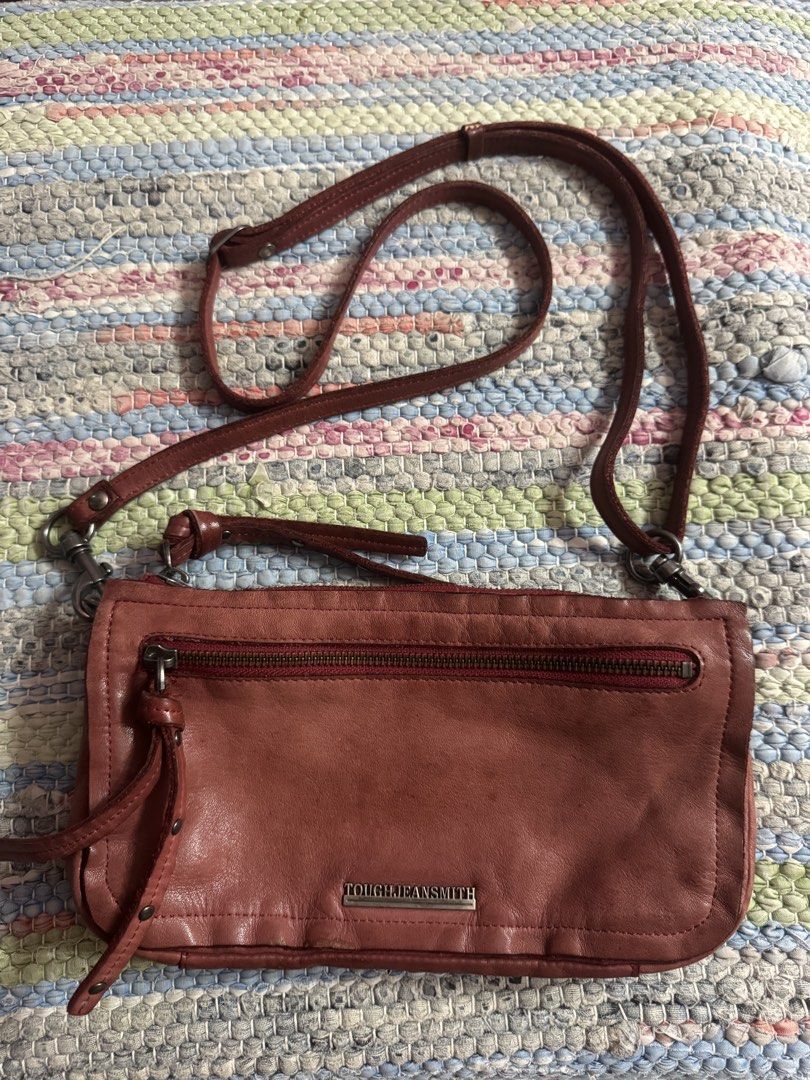 Tough Jeansmith Leather Crossbody Bag (Category: Cross-body Bags) located in Makati City. Submitted by vinsanity41546 (Listing ID 1448445950, Image 1). Description: - Genuine Tough Jeansmith leather crossbody bag - Multiple zippered compartments for secure storage - Interior card slots for organization - Adjustable strap for comfortable wear - Stylish worn-in leather look - Ideal for everyday use.