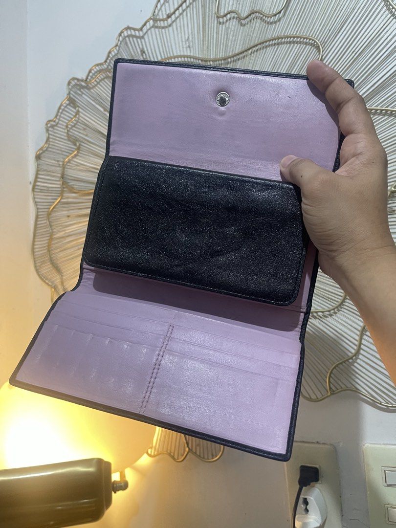 Vintage Coach Black Leather Trifold Wallet (Category: Wallets & Card holders) located in Urdaneta. Submitted by picky_picker (Listing ID 1448460381, Image 3). Description: - Brand: Coach - Complete with its Cheque Book wallet insert - Material: Black Leather - Interior Color: Light Purple - Style: Trifold Wallet - Features: Multiple card slots, ample compartments, back zippered coin pocket - Condition: Shows some signs of wear on the leather, par