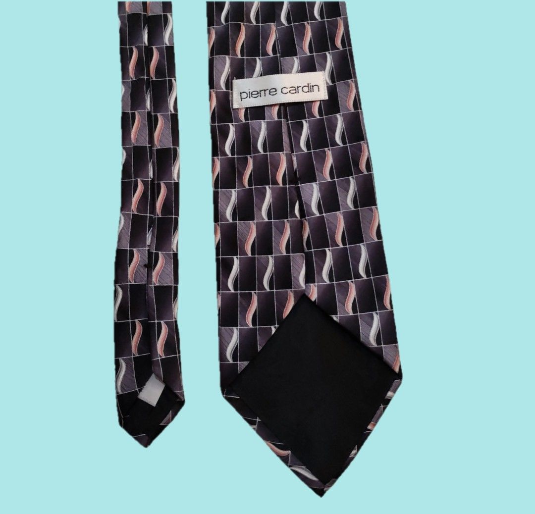 Vintage Pierre Cardin Silk Tie - Geometric Pattern (Category: Ties) located in Dinalupihan. Submitted by senkustuff (Listing ID 1448372759, Image 3). Description: - Classic Pierre Cardin tie - Made from 100% silk - Features a dark geometric pattern - Wavy lines in shades of grey, pink, and white - Ideal for formal occasions or adding sophistication to any outfit - Looks sharp and stylish.