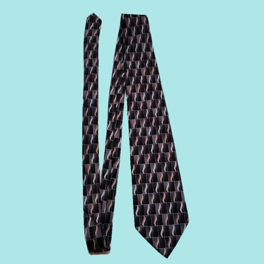 Vintage Pierre Cardin Silk Tie - Geometric Pattern (Category: Ties) located in Dinalupihan. Submitted by senkustuff (Listing ID 1448372759, Image 2). Description: - Classic Pierre Cardin tie - Made from 100% silk - Features a dark geometric pattern - Wavy lines in shades of grey, pink, and white - Ideal for formal occasions or adding sophistication to any outfit - Looks sharp and stylish.