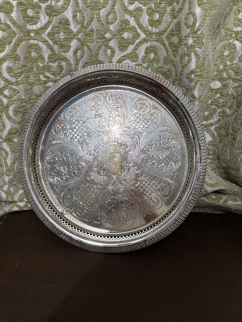 Vintage Silver Plated Serving Tray with Ornate Design (Category: Other Kitchenware & Tableware) located in Quezon City. Submitted by elektra0111 (Listing ID 1448479975, Image 2). Description: - Vintage round serving tray - Silver plated with intricate embossed floral and scroll pattern - Decorative rim with cut-out details - Ideal for serving drinks or as a decorative accent piece - diameter 29cm outside / 25 cm inner .
