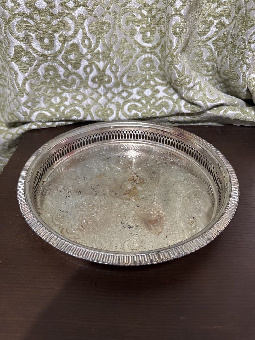Vintage Silver Plated Serving Tray with Ornate Design (Category: Other Kitchenware & Tableware) located in Quezon City. Submitted by elektra0111 (Listing ID 1448479975, Image 1). Description: - Vintage round serving tray - Silver plated with intricate embossed floral and scroll pattern - Decorative rim with cut-out details - Ideal for serving drinks or as a decorative accent piece - diameter 29cm outside / 25 cm inner .