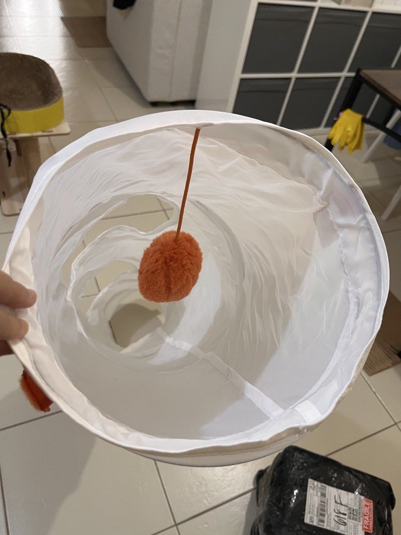 White Cat Tunnel with Dangling Toy (Category: Homes & Other Pet Accessories) located in Taguig. Submitted by larabae.333 (Listing ID 1448479845, Image 3). Description: - Fun tunnel for cats to play and hide. - Side openings for extra interactive play. - Includes a fluffy orange ball for batting. - Folds flat for convenient storage. - Keeps your feline friend entertained..