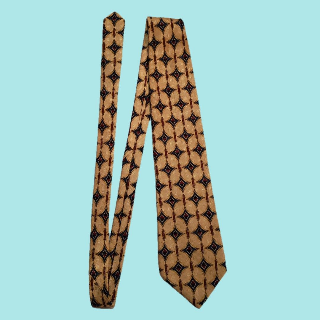 XMI for Nordstrom Silk Tie (Category: Ties) located in Dinalupihan. Submitted by senkustuff (Listing ID 1448373243, Image 2). Description: - Gold tie with a sophisticated geometric pattern. - Features navy blue and burgundy diamond shapes in an oval design. - Hand-sewn quality by XMI for Nordstrom. - An excellent accessory to elevate any formal outfit. - Adds a timeless, classic touch to your ensemble..