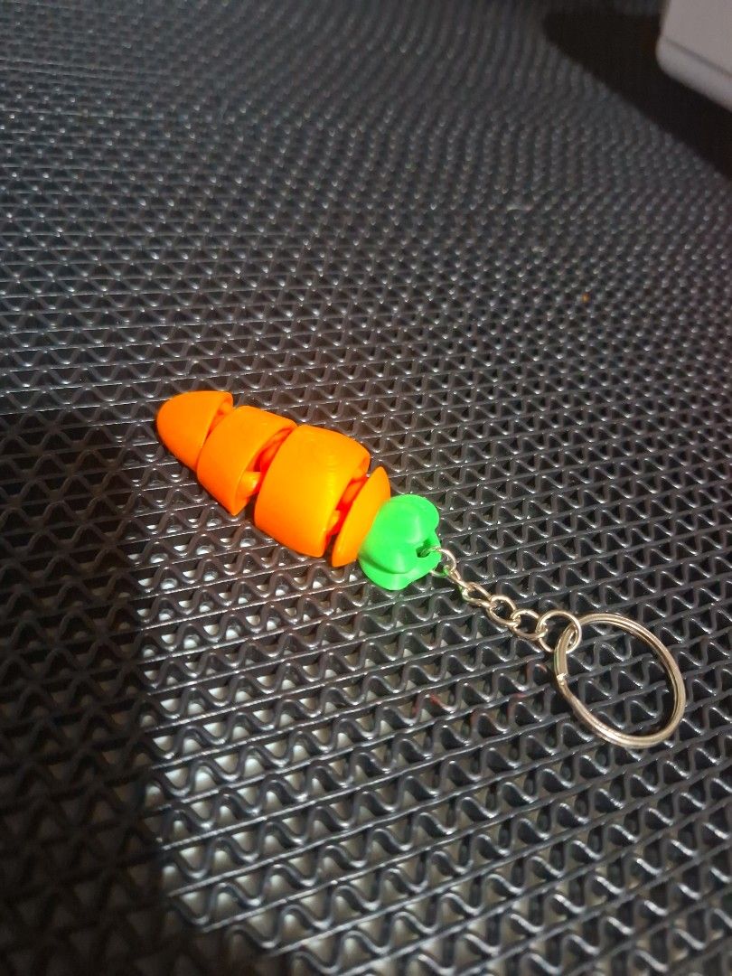 3D Printed Articulated Carrot Keychain (Category: Character Goods) located in Quezon City. Submitted by laniestore (Listing ID 1448490686, Image 2). Description: - Cute 3D printed carrot keychains - Orange body with green topoo - Articulated/bendable design - Great for bags, backpacks, or as a fun accessory - Makes a unique gift - Sold as a set 10pcs -Php.300 Per piece php.25 pesos.