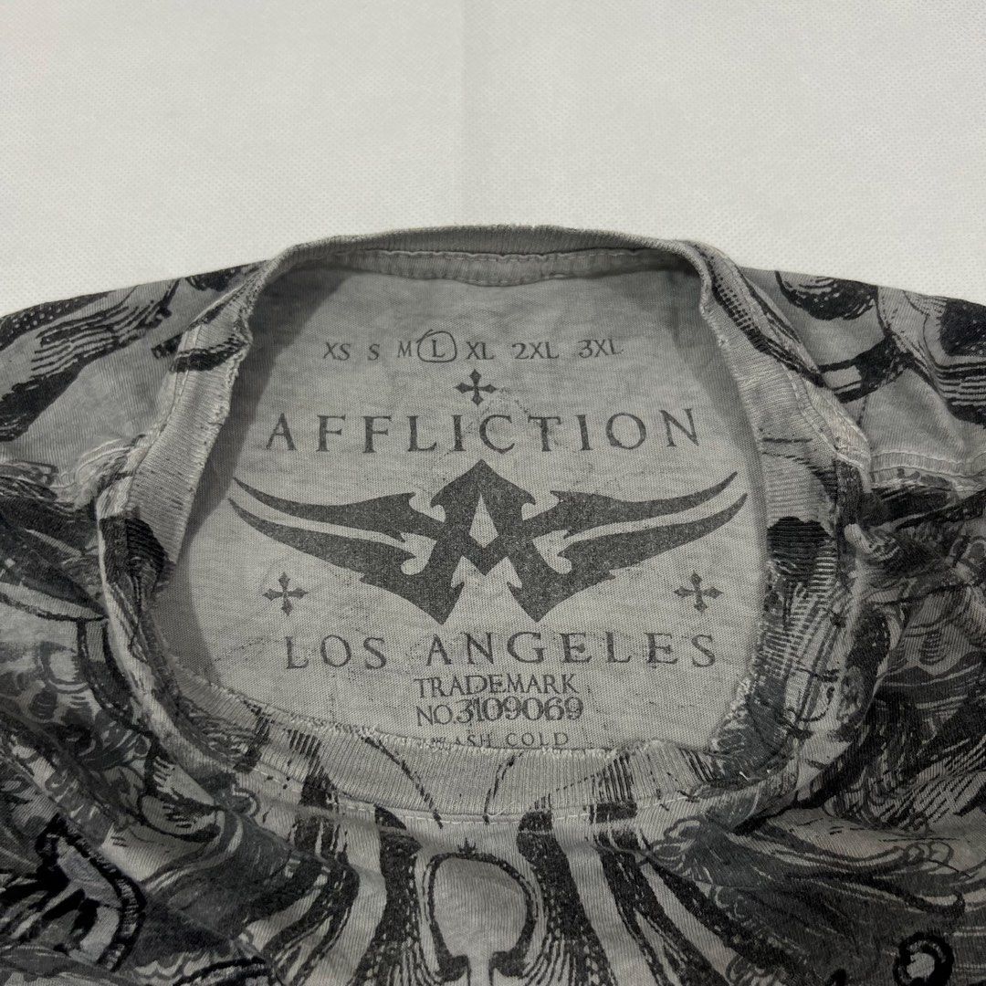 Affliction Homage Light Gray Tee (tags: AFFLICTION, TAPOUT, MMA ELITE, SOUTHPOLE, JNCO, GRUNGE, METAL MULISHA, XZAVIER, XTREME COUTURE, Y2K, ALTERNATIVE, BAGGY, CYBERCORE, KARL KANI, SEAN JOHN, ARCHAIC, RAW STATE, OAKLEY, SKATE) (Category: Tshirts & Polo Shirts ) located in Cavite. Submitted by itsayaaa (Listing ID 1448676447, Image 3). Description: .
