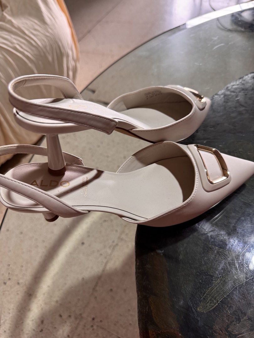 ALDO White Slingback Heels with Gold Buckle (Category: Heels) located in Marikina City. Submitted by 1stuffshop (Listing ID 1448485468, Image 2). Description: - Brand: ALDO - Style: White slingback heels - Features: Pointed toe, gold buckle detail, adjustable ankle strap - Heel Height: Moderate - Condition: Soles show some signs of wear - Versatility: Great for dressing up or down.