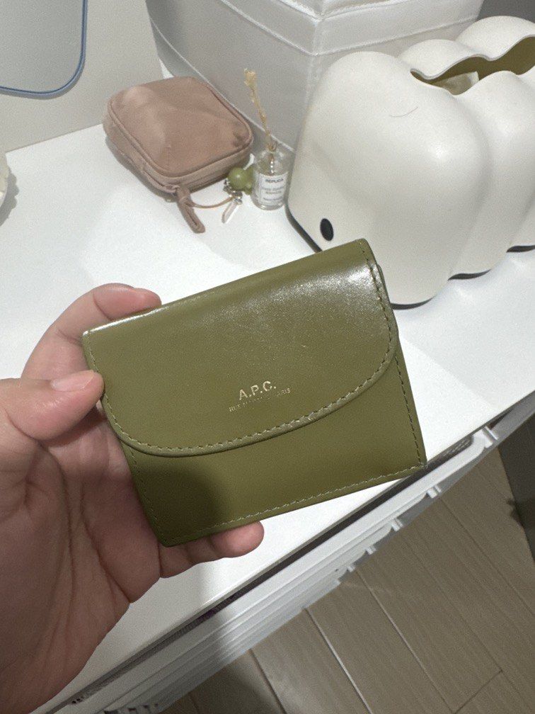 A.P.C. Geneve Trifold Wallet in Olive (Category: Wallets & Card holders) located in Taguig. Submitted by blessthismessph (Listing ID 1440497638, Image 2). Description: - Olive green trifold wallet - Brand: A.P.C. - Made in France - Embossed A.P.C. logo on front flap - Compact size, perfect for essentials - Material: Leather - Clean and simple design Actual photos available upon request, dust pouch included. Retails 14K, slightly negotiable but no