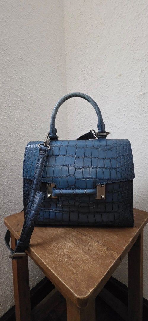 Authentic DECKE Designer Structured Top Handle & Crossbody Bag - Croc Embossed (Category: Luxury Bags & Wallets) located in Manila. Submitted by amc88 (Listing ID 1448582864, Image 1). Description: ​Up for sale is a stunning, architectural structured handbag from the premium contemporary designer label DECKE (known for its luxury leather craftsmanship and international debut at London Fashion Week). Can be carried elegantly by its rigid top handl
