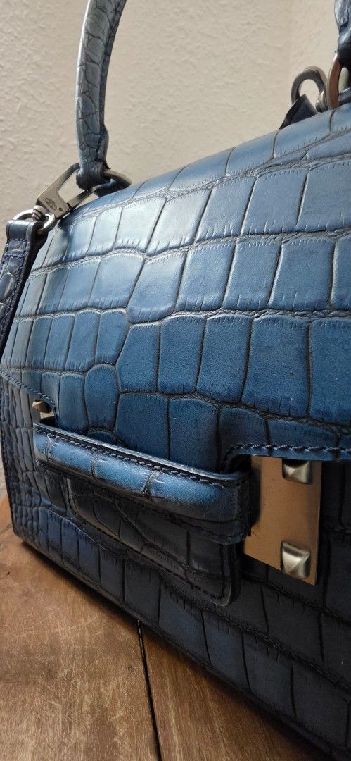 Authentic DECKE Designer Structured Top Handle & Crossbody Bag - Croc Embossed (Category: Luxury Bags & Wallets) located in Manila. Submitted by amc88 (Listing ID 1448582864, Image 2). Description: ​Up for sale is a stunning, architectural structured handbag from the premium contemporary designer label DECKE (known for its luxury leather craftsmanship and international debut at London Fashion Week). Can be carried elegantly by its rigid top handl