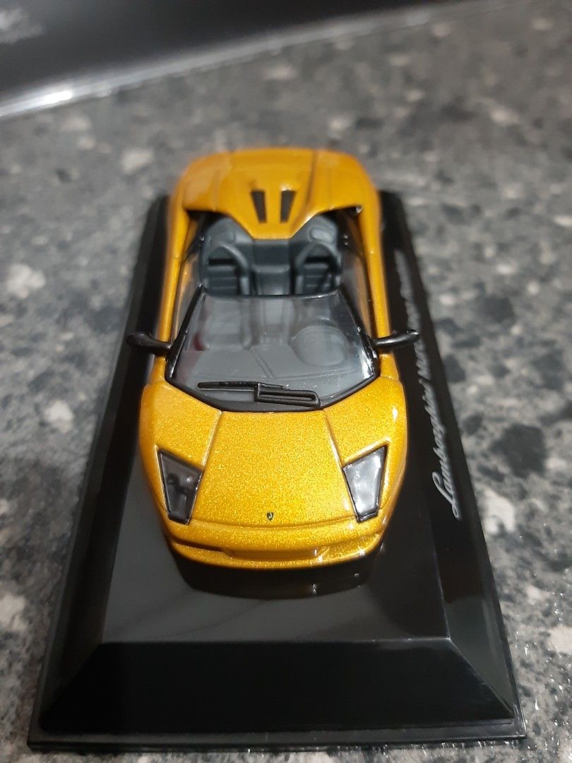 AUTOart Lamborghini 1/64 (Category: Vehicle & Diecast Models) located in Bacoor. Submitted by Sky10629 (Listing ID 1448668909, Image 3). Description: AUTOart Diecast 1/64 Lamborghini Murcielago Roadster Metallic gold paint body In pedestal and acrylic cover rare / collectors item .