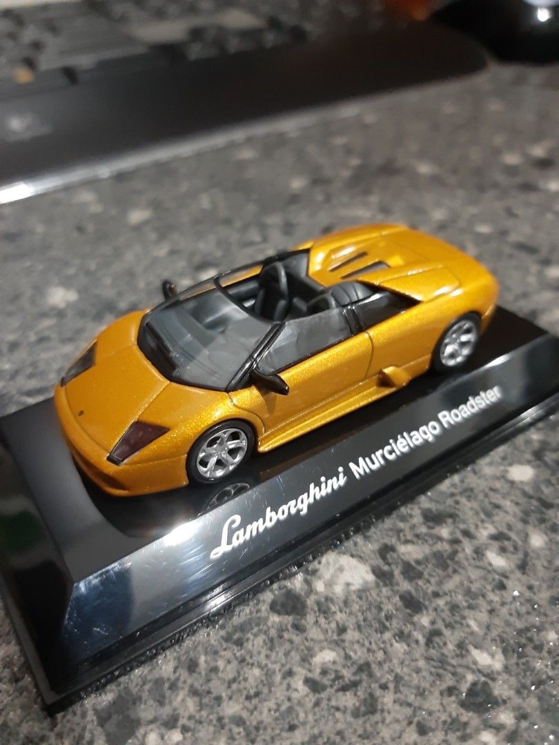 AUTOart Lamborghini 1/64 (Category: Vehicle & Diecast Models) located in Bacoor. Submitted by Sky10629 (Listing ID 1448668909, Image 1). Description: AUTOart Diecast 1/64 Lamborghini Murcielago Roadster Metallic gold paint body In pedestal and acrylic cover rare / collectors item .