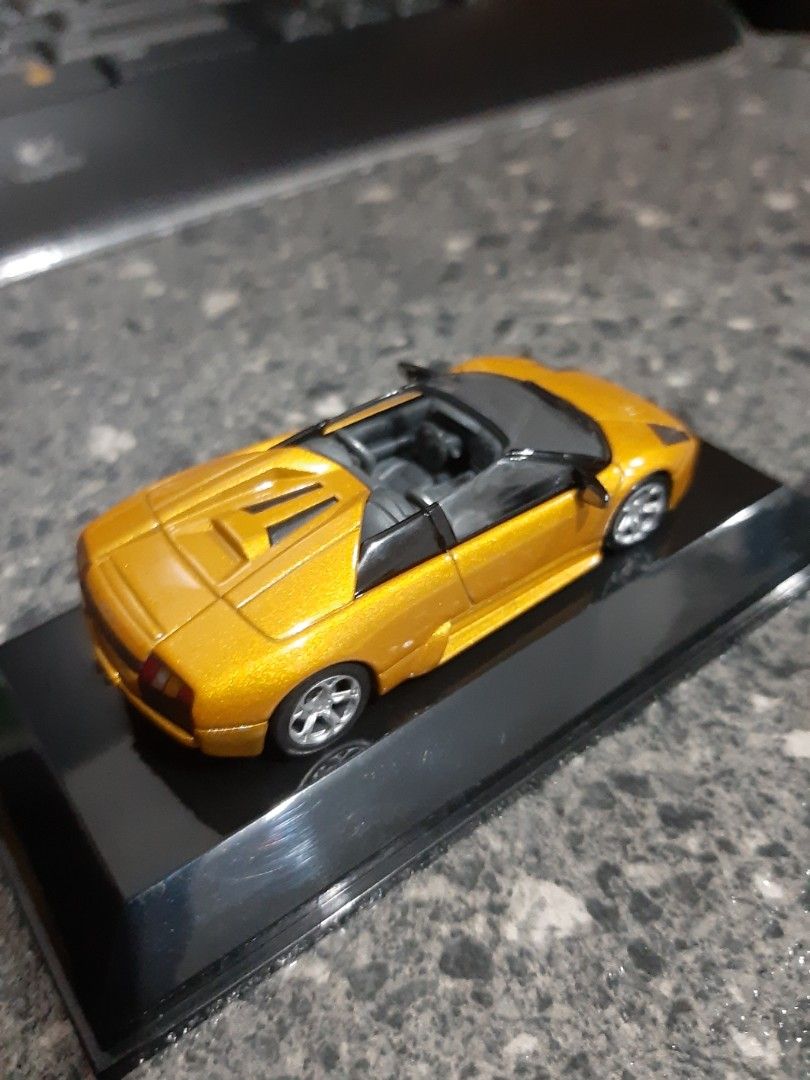 AUTOart Lamborghini 1/64 (Category: Vehicle & Diecast Models) located in Bacoor. Submitted by Sky10629 (Listing ID 1448668909, Image 2). Description: AUTOart Diecast 1/64 Lamborghini Murcielago Roadster Metallic gold paint body In pedestal and acrylic cover rare / collectors item .