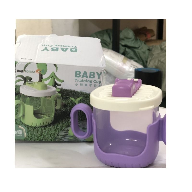 Baby Training Cup with Handles (Category: Weaning & Toddler Feeding) located in Makati City. Submitted by luckymoon_065c27 (Listing ID 1448569559, Image 1). Description: - Cute baby training cup - Features easy-grip handles - Fun crocodile design on the lid - Ideal for teaching independent drinking - Comes with original box - Makes a perfect gift.