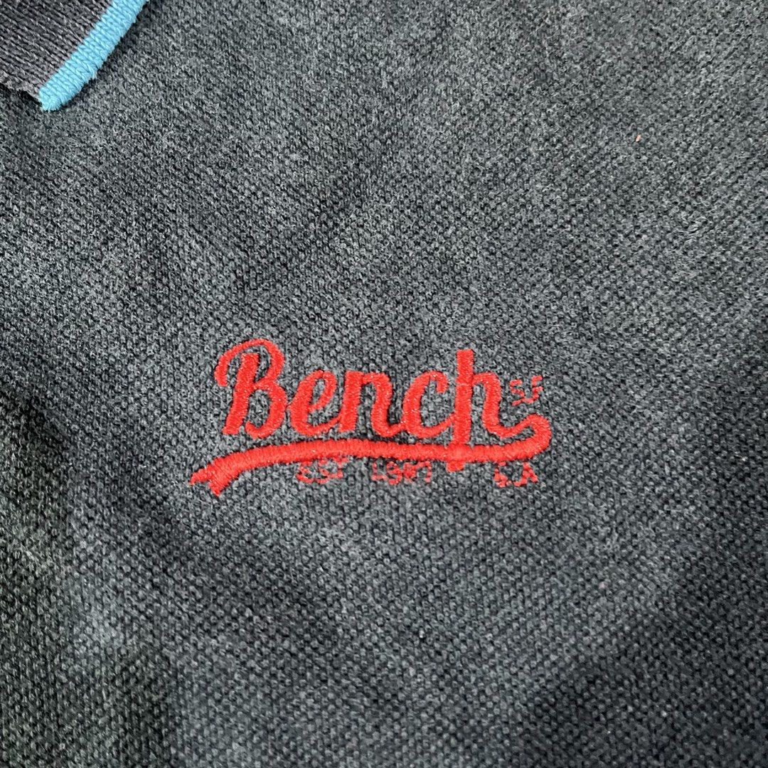 Bench Dark Blue Polo Shirt XXLarge (Category: Tshirts & Polo Shirts ) located in Catarman. Submitted by gadabells (Listing ID 1448523917, Image 3). Description: - Dark blue Bench polo shirt - Size XXLarge - Red embroidered Bench logo on chest - Blue trim on collar and sleeves - Button-up neckline - Ideal for casual wear.