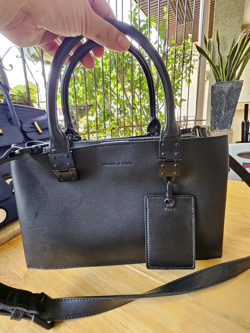 Black Leather Handbag with Shoulder Strap (Category: Shoulder Bags) located in Cabanatuan. Submitted by eclaudio (Listing ID 1448610394, Image 1). Description: - Genuine black leather handbag - Features a comfortable top handle - Comes with a detachable shoulder strap for versatility - Includes a stylish small luggage tag - Minor scuffs on the leather, adding character - Interior is clean and well-maintained - Ready for its next adventure!.