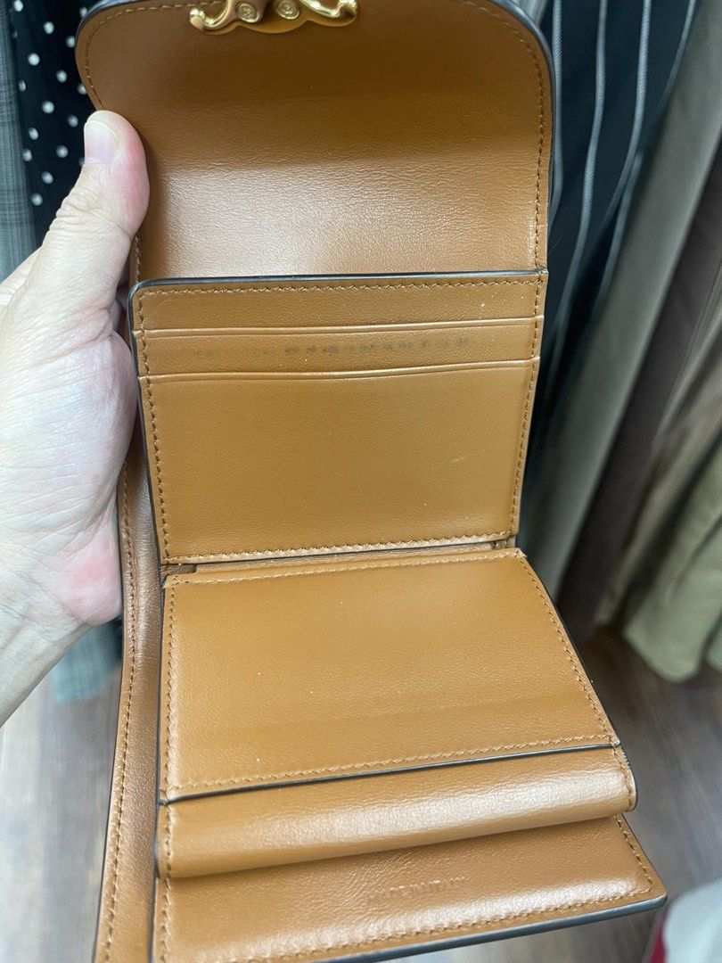 Celine Triomphe Canvas & Leather Wallet (Category: Luxury Bags & Wallets) located in Quezon City. Submitted by maria___x (Listing ID 1448693843, Image 3). Description: - Authentic Celine Triomphe wallet - Beige canvas with tan leather trim - Iconic Triomphe logo clasp - Interior card slots and coin pocket - Made in Italy - Perfect for organizing essentials.