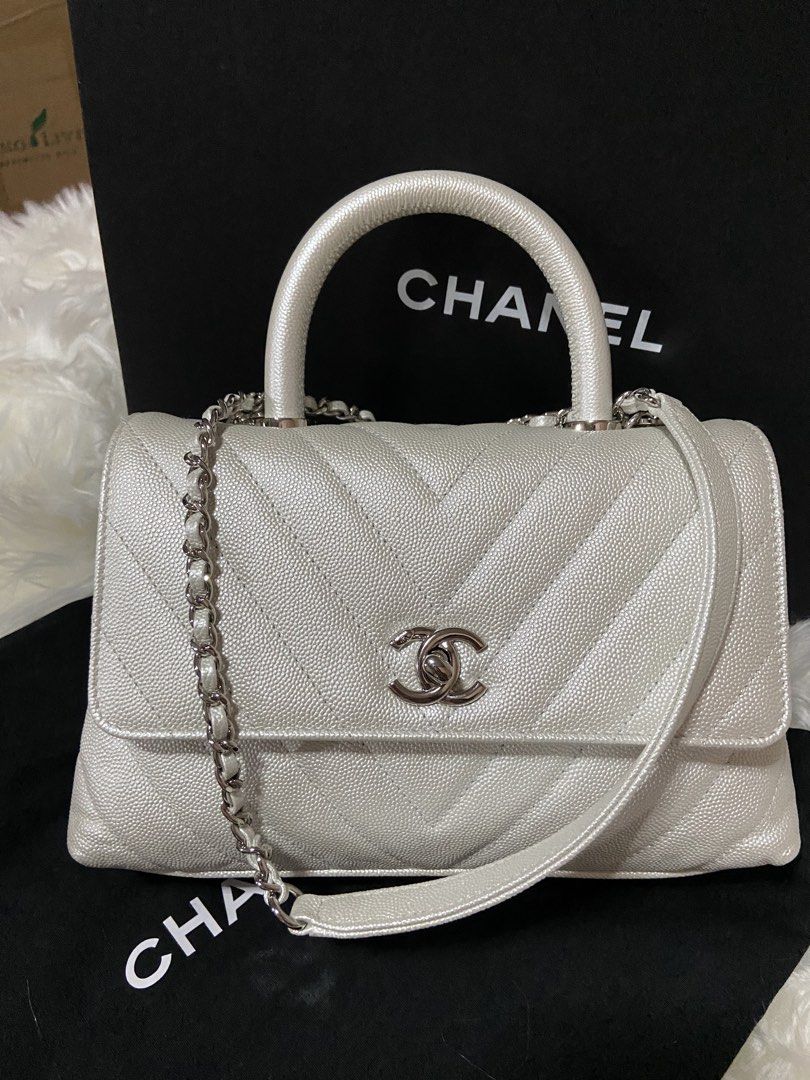 Chanel Handle Bag White Chevron Caviar Leather (Category: Luxury Bags & Wallets) located in Marikina City. Submitted by luxurlizzy (Listing ID 1448541180, Image 1). Description: White Chanel handle bag. Chevron pattern. Caviar leather. Silver hardware. Comes with authenticity card and dust bag. Chain strap is detachable. Great for day or night..