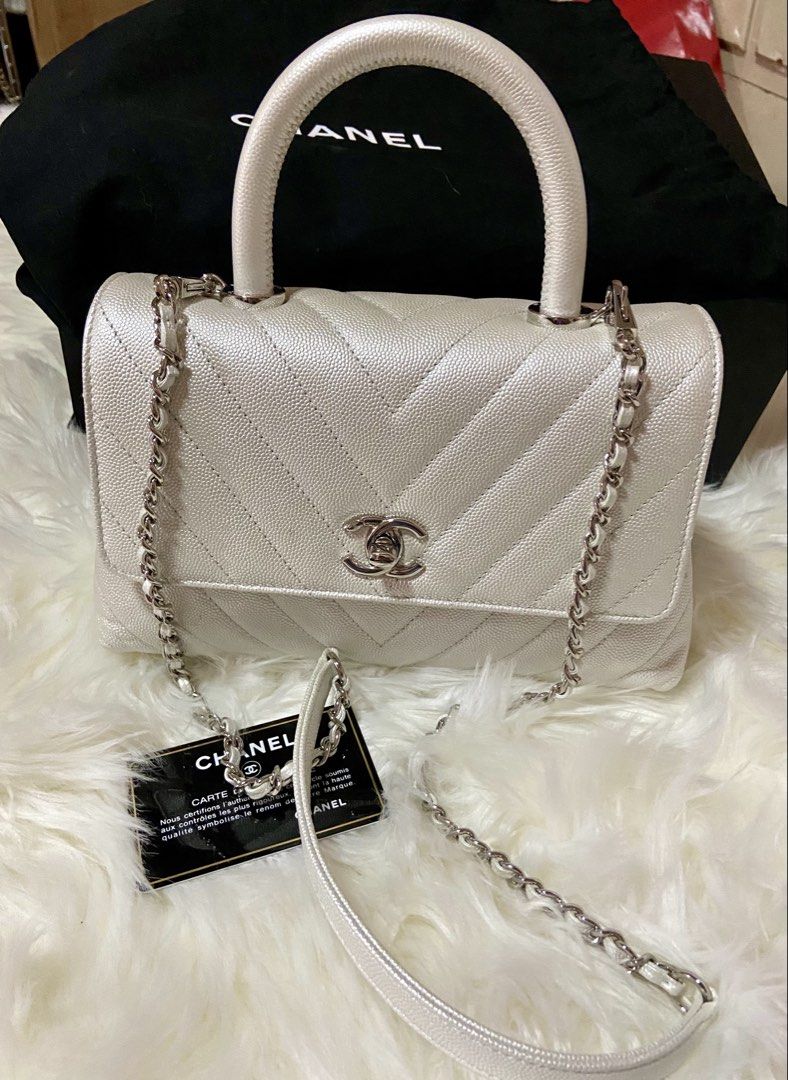 Chanel Handle Bag White Chevron Caviar Leather (Category: Luxury Bags & Wallets) located in Marikina City. Submitted by luxurlizzy (Listing ID 1448541180, Image 2). Description: White Chanel handle bag. Chevron pattern. Caviar leather. Silver hardware. Comes with authenticity card and dust bag. Chain strap is detachable. Great for day or night..