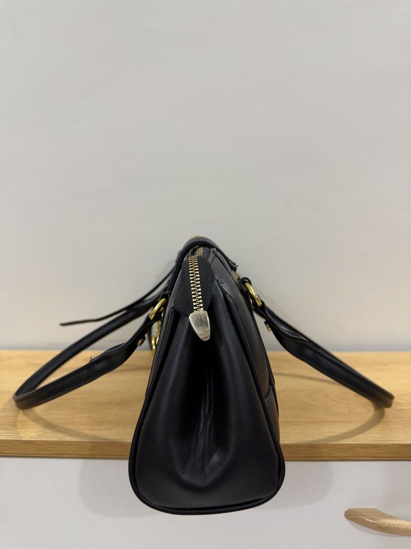 City Shoulder Bag (Category: Shoulder Bags) located in Manila. Submitted by sheisdecluttering (Listing ID 1448624156, Image 3). Description: - Classic black leather handbag - Gold-tone hardware - Secure clasp closure - Multiple interior compartments for organization - Top handles for carrying - Versatile for daily use or special occasions - Clean and well-maintained.