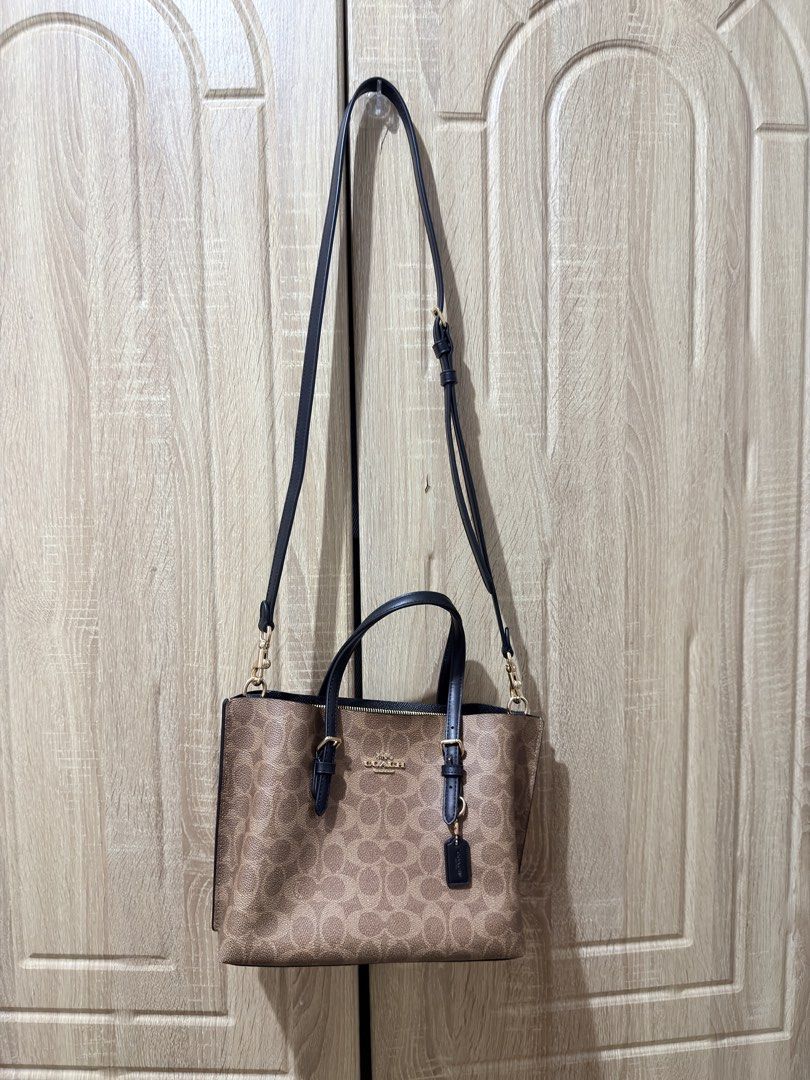 Coach Mollie Tote 25 (Category: Luxury Bags & Wallets) located in San Mateo. Submitted by eunoiaclothingph2.0 (Listing ID 1448610960, Image 2). Description: - Coach tote bag in signature C print - Tan and brown canvas with black leather handles and trim - Gold hardware details - Detachable crossbody strap included - Secure zipper closure on top - Comes with original Coach hangtag - Ideal for everyday use Original Price: 21k+ Comes with dustbag an