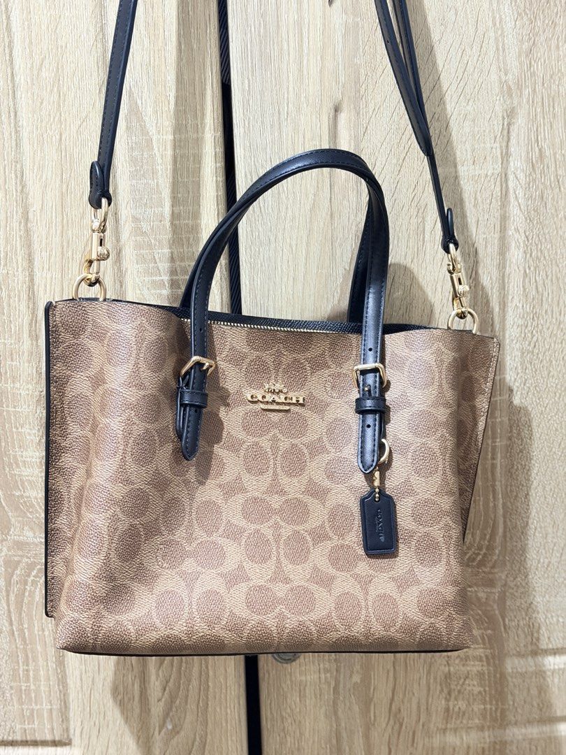 Coach Mollie Tote 25 (Category: Luxury Bags & Wallets) located in San Mateo. Submitted by eunoiaclothingph2.0 (Listing ID 1448610960, Image 3). Description: - Coach tote bag in signature C print - Tan and brown canvas with black leather handles and trim - Gold hardware details - Detachable crossbody strap included - Secure zipper closure on top - Comes with original Coach hangtag - Ideal for everyday use Original Price: 21k+ Comes with dustbag an