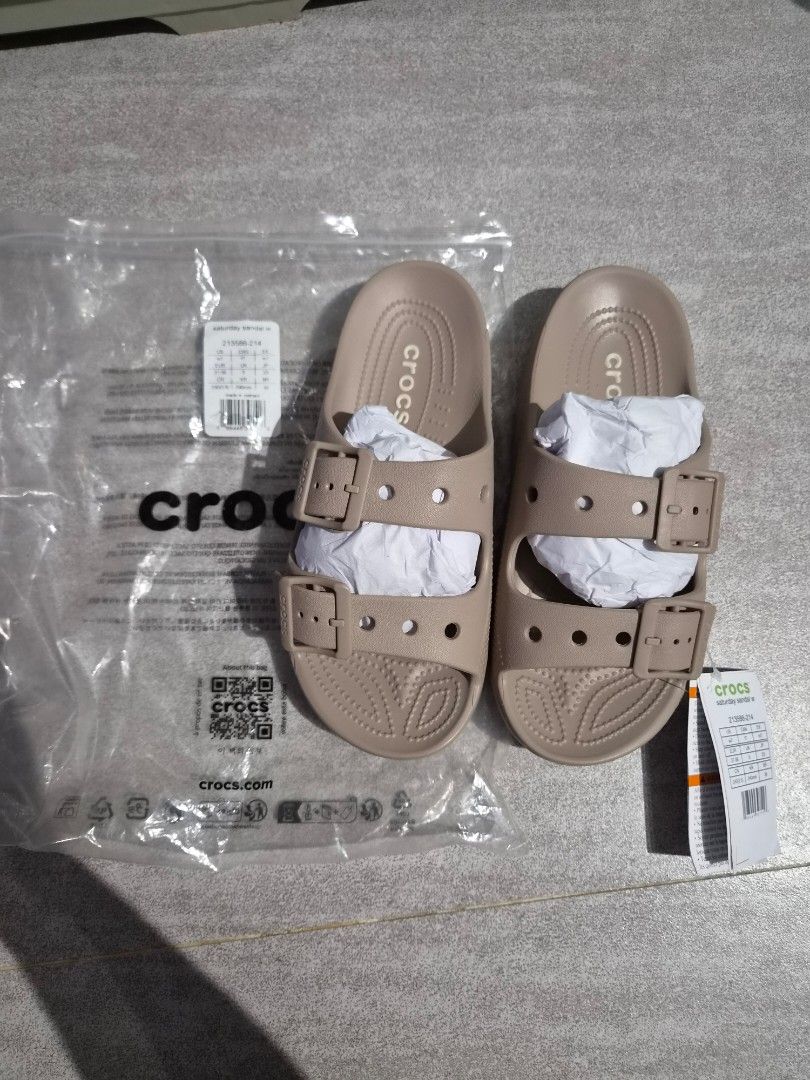 Crocs Beige Double Strap Slides Sandals Size 7 (Category: Flats & Sandals) located in Taguig. Submitted by orange_potion (Listing ID 1448606153, Image 1). Description: - Beige Crocs slides - Women's size 7 - Double strap design with adjustable buckles - Brand new with original tags attached - Comes in original plastic bag - Ideal for casual outings or lounging at home.