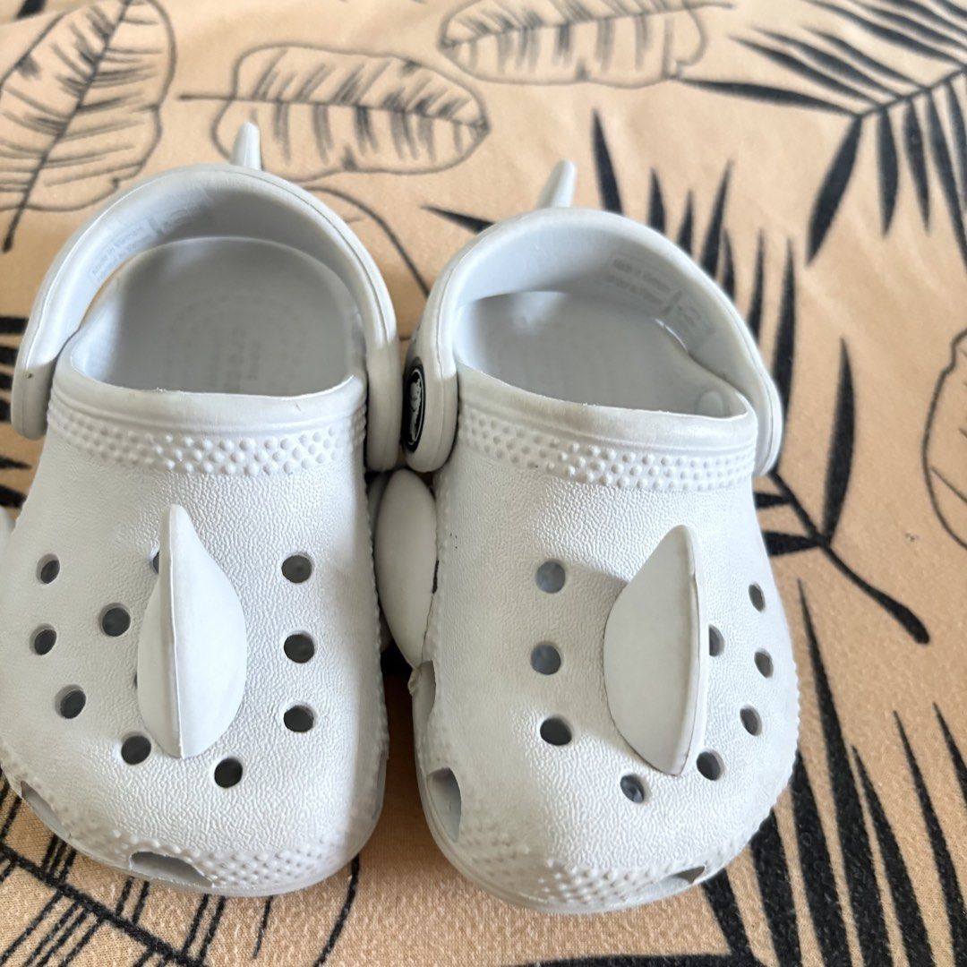 Crocs Toddler Shark Clogs Size 4 White (Category: Babies & Kids Fashion) located in Cavite. Submitted by savannahluish (Listing ID 1448599702, Image 1). Description: - Cute white Crocs clogs for kids - Fun shark fin design - Easy slip-on and off - Perfect for beach or playground - Good grip soles - Size 4.