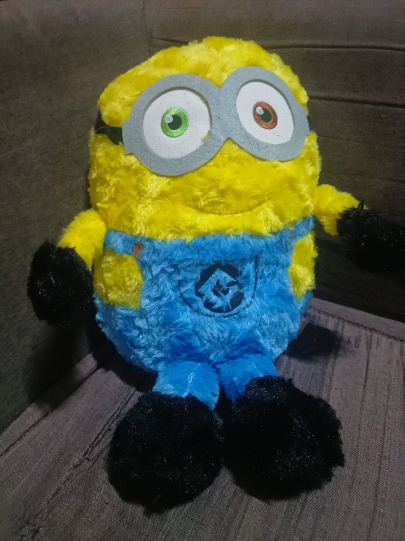 Despicable Me 3 Minion Plush Toy (Category: Plushies & Soft Toys) located in Taal. Submitted by zildreiven (Listing ID 1448568262, Image 1). Description: - Cute Minion plush toy from Despicable Me 3 - Soft and fluffy yellow body - Wears iconic blue overalls - Features one green eye and one brown eye - Perfect for Despicable Me fans - Ideal for cuddling or as a display piece.