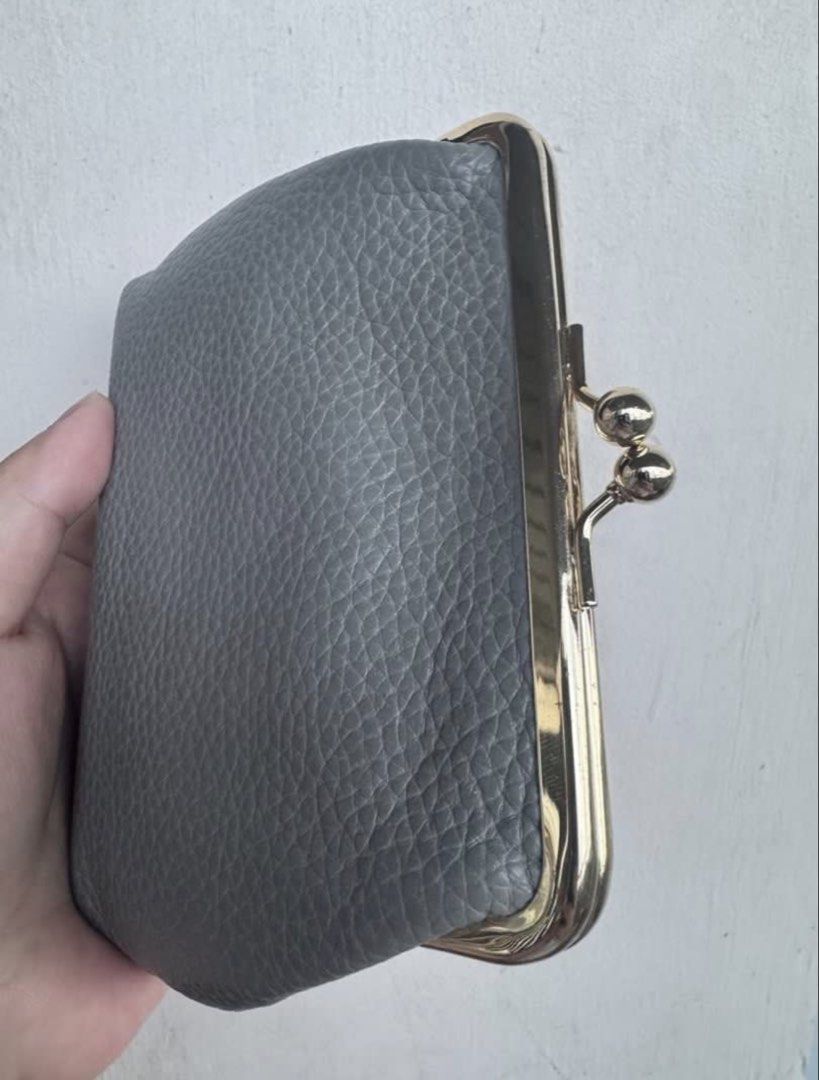 Dooney & Bourke Grey Leather Coin Purse (Category: Wallets & Card holders) located in Binangonan. Submitted by joizeeful (Listing ID 1448646307, Image 2). Description: - Authentic Dooney & Bourke coin purse - Grey pebbled leather exterior - Gold-tone kiss clasp closure - Red interior with card slots - Made with 100% leather (body & trim) - Small and compact, ideal for essentials.