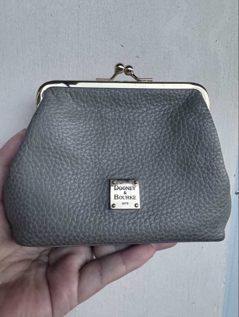 Dooney & Bourke Grey Leather Coin Purse (Category: Wallets & Card holders) located in Binangonan. Submitted by joizeeful (Listing ID 1448646307, Image 1). Description: - Authentic Dooney & Bourke coin purse - Grey pebbled leather exterior - Gold-tone kiss clasp closure - Red interior with card slots - Made with 100% leather (body & trim) - Small and compact, ideal for essentials.