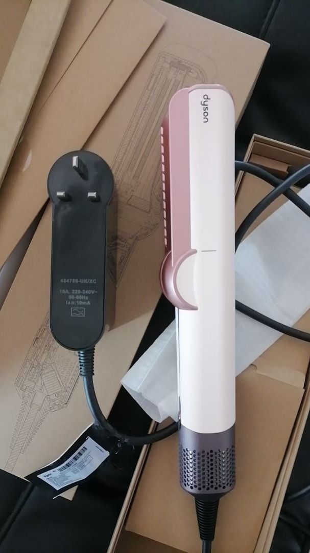 Dyson Airwrap Styler - Pink & Rose Gold (Category: Hair) located in Pateros City. Submitted by nisfarxald25135 (Listing ID 1448490325, Image 2). Description: - Dyson Airwrap styler in stylish pink and rose gold. - Includes charging cord and plug. - Original box included. - Achieve beautiful hairstyles with ease..