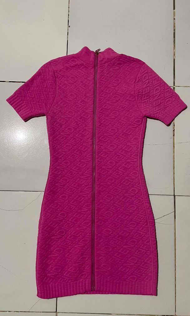 Fendi Pink Knit Dress (Category: Dresses) located in Barotac Nuevo. Submitted by gray101 (Listing ID 1437263542, Image 2). Description: - Fendi knit dress in vibrant pink. - Size: M - Style: Bodycon - Features: Textured pattern, short sleeves, and zip-up front. - Design: Mock neck. - Condition: Excellent, eye-catching piece..
