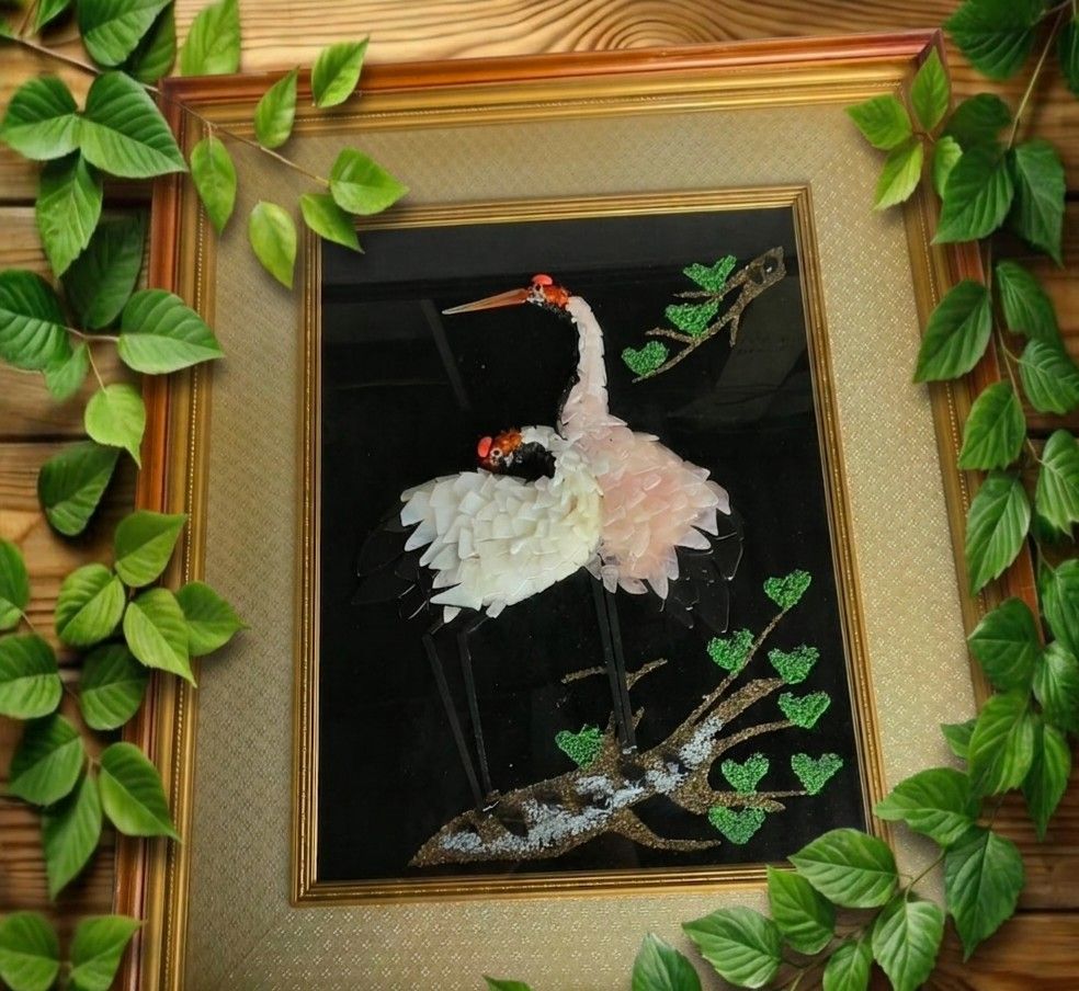 Framed Crane Artwork - Unique 3D Textured Piece (Category: Frames & Pictures) located in Naga. Submitted by solamia (Listing ID 1448596036, Image 1). Description: - Stunning framed artwork featuring two elegant cranes. - Cranes have a unique 3D effect due to textured, layered material. - Deep black background with a natural branch and vibrant green leaves. - Elegant wooden frame with a classic gold trim. - Generous size: approximately 20 inches b