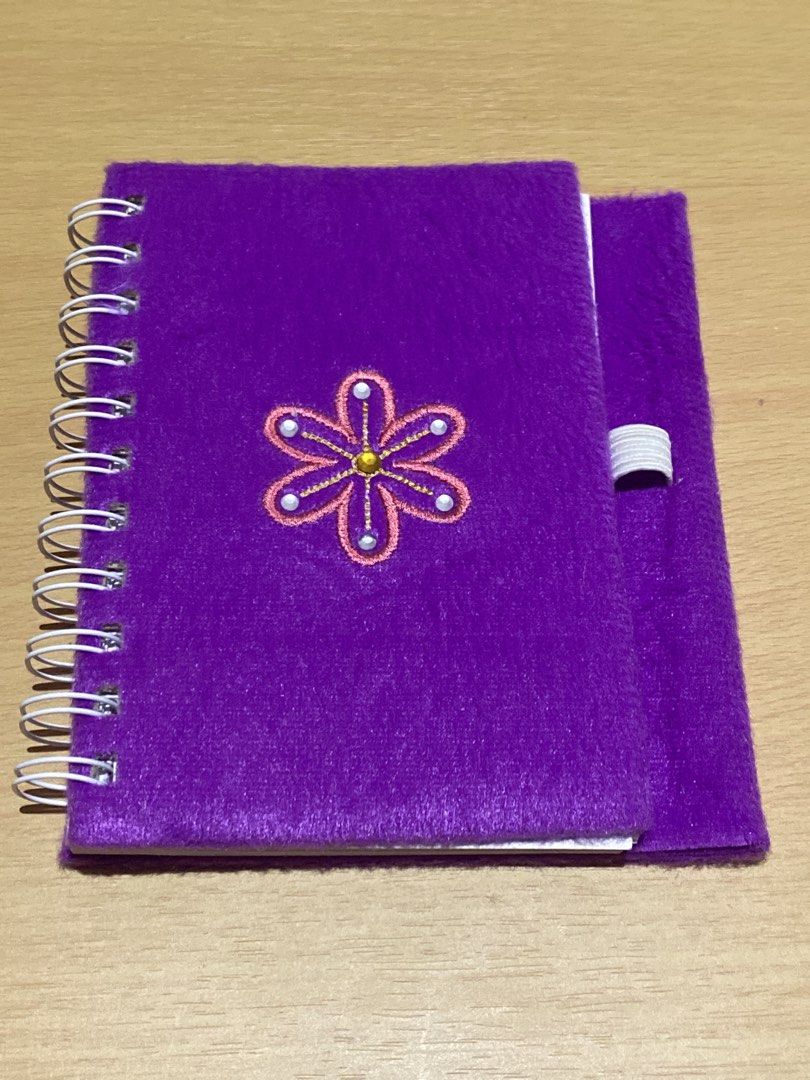 Fuzzy Purple Notebook with Flower Design (Category: Stationery & School Supplies) located in Dasmarinas. Submitted by ae.decluttering (Listing ID 1448601078, Image 1). Description: - Cute fuzzy purple notebook - Flower design on the front cover - Spiral bound - Lined pages inside - Elastic band closure - Ideal for notes or diary - No pen included .