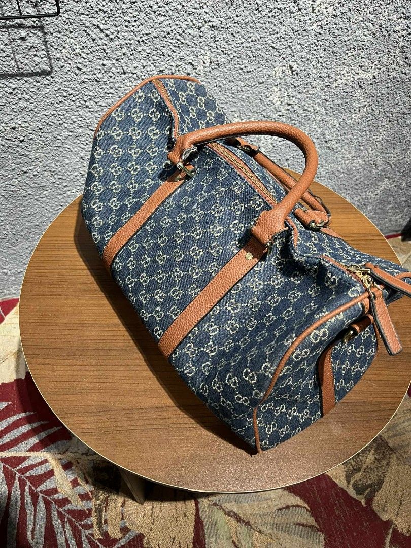 Gucci GG Denim Duffle Bag (Category: Luxury Bags & Wallets) located in Manila. Submitted by young4tez (Listing ID 1448577467, Image 3). Description: - Classic Gucci duffle bag - Iconic GG monogram pattern on denim - Brown leather trim and handles - Zipper closure - Interior zippered pocket - Ideal for weekend trips or carry-on.