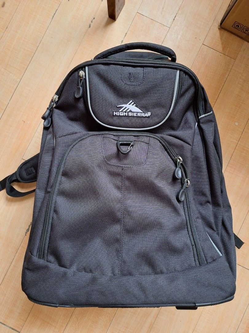 High Sierra Powerglide Wheeled Backpack (Category: Backpacks) located in Iloilo. Submitted by declutterbuddy08 (Listing ID 1448559055, Image 1). Description: - Black High Sierra rolling backpack - Features wheels and a retractable handle for easy transport - Multiple compartments and pockets for excellent organization - Includes padded shoulder straps for comfortable carrying - Ideal for travel or school use.