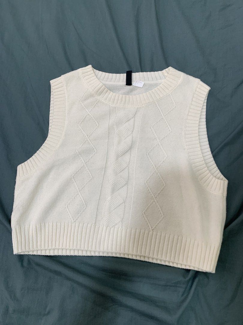 H&M Divided Cream Cable Knit Sweater Vest (Category: Sleeveless) located in Binan City. Submitted by bentenison (Listing ID 1448564528, Image 1). Description: - Cream cable knit sweater vest - Brand: H&M Divided - Size: L - Approx. Length: 18 inches - Approx. Width: 19 inches - Cozy knit material - Versatile for layering over shirts or wearing solo.