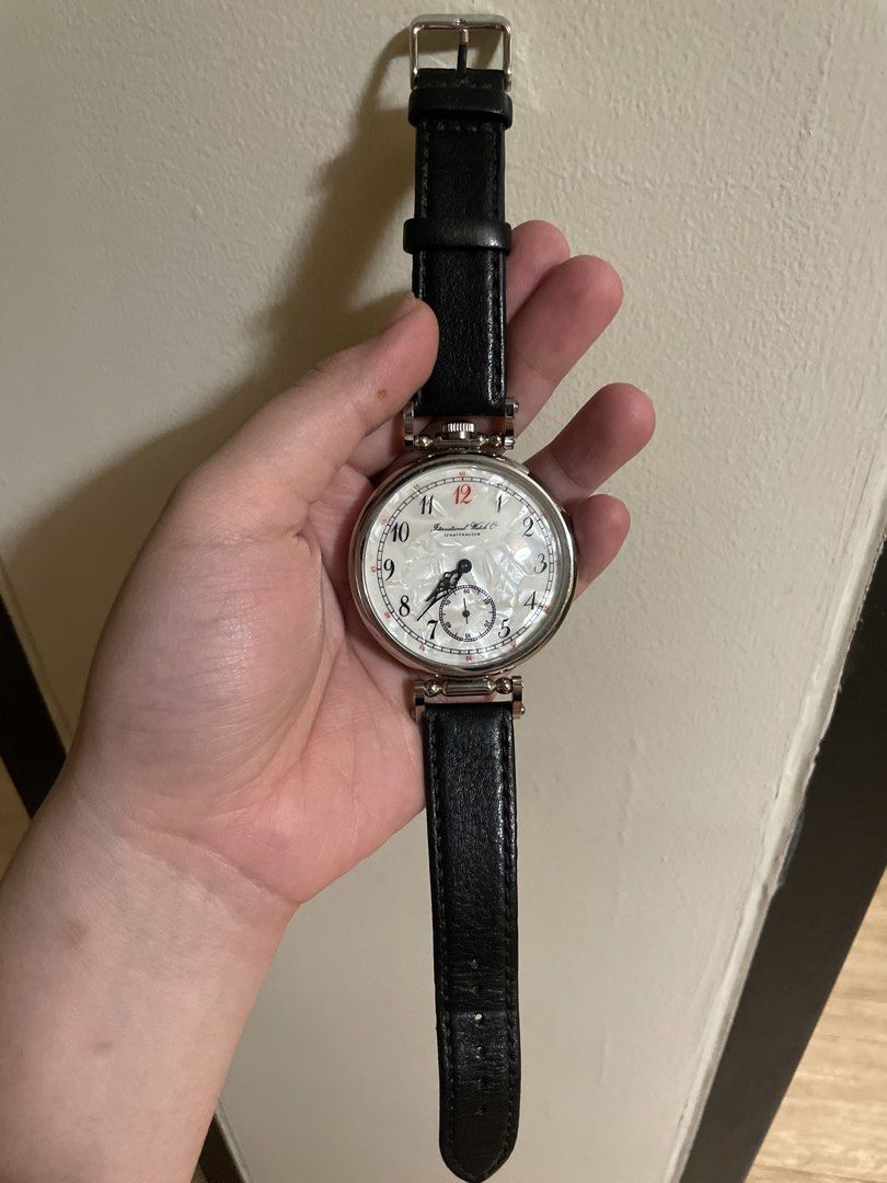 IWC Schaffhausen Pocket Watch Conversion Wristwatch (Category: Men's Watches) located in Agdangan. Submitted by kikayfindsph (Listing ID 1448658937, Image 2). Description: A vintage IWC Schaffhausen dress watch featuring a striking oversized round stainless-steel case and an elegant white/silver mother-of-pearl-style textured dial. The dial is accented with classic black Arabic numerals, a red 12, red minute-track markings, elegant blued/black ha