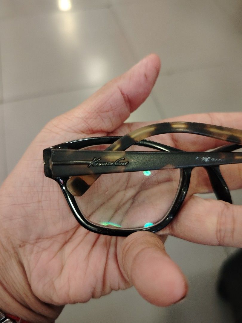 Kenneth Cole New York Eyeglasses Black Tortoise Shell Frames (Category: Sunglasses & Eyewear) located in Manila. Submitted by purediamond888 (Listing ID 1448576011, Image 3). Description: - Brand: Kenneth Cole New York - Frame Color: Black with Tortoise Shell Arms - Shape: Classic Rectangular - Condition: Lenses are clear and ready for prescription - Style: Perfect for everyday wear, a stylish accessory.