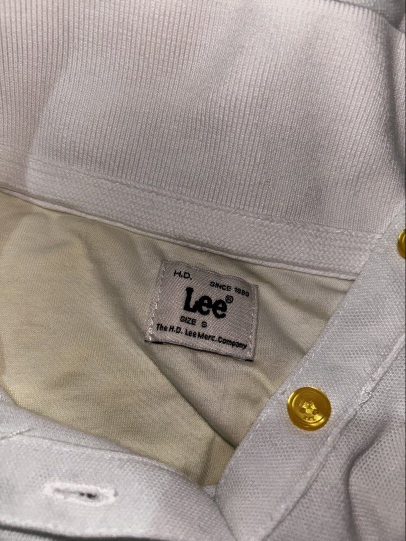 Lee White Short Sleeve Polo Shirt (Category: Shirts) located in Cebu City. Submitted by _____08_____ (Listing ID 1448618695, Image 2). Description: - Classic white polo shirt from Lee - Features a collar and button-up front - Stylish gold-tone buttons - Embroidered Lee logo on the chest - Versatile for casual or sporty looks - Easy to pair with any bottoms.