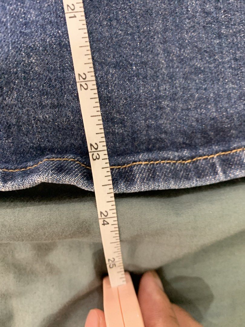 Levi's Denim Midi Skirt - Size 26 (Category: Skirts) located in Binan City. Submitted by bentenison (Listing ID 1448569154, Image 2). Description: - Classic blue denim midi skirt by Levi's - Features a stylish front slit for ease of movement - Waistband measures 28 inches - Skirt length is approximately 23 inches - A versatile staple piece for any outfit.
