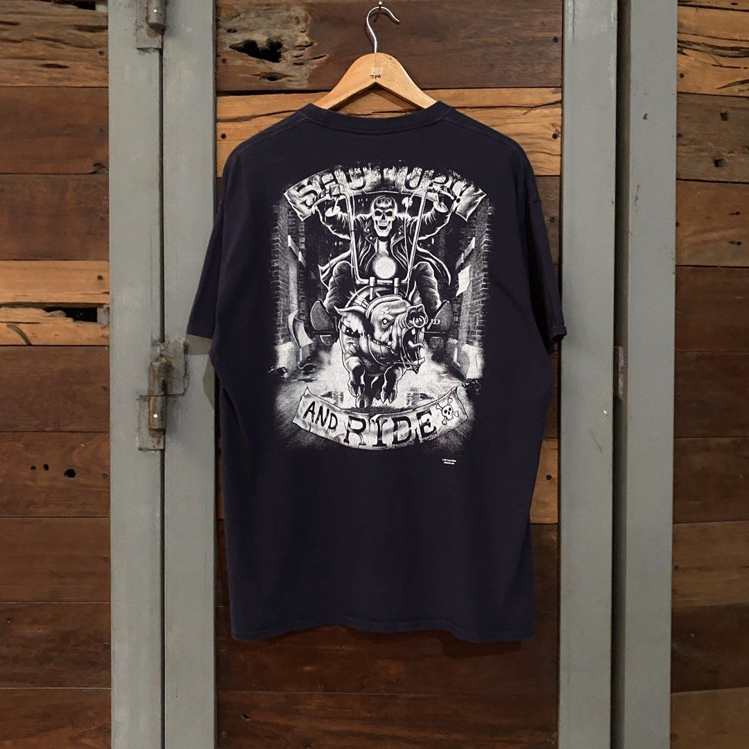 Liquid Blue Trademark " Shut up n Ride" (Category: Tshirts & Polo Shirts ) located in Los Banos. Submitted by rick_06 (Listing ID 1448682708, Image 1). Description: - Navy blue Port & Company graphic tee - Features a striking skull and motorcycle design on the back - Plain navy front - Made from 100% comfortable cotton - Ideal for everyday casual wear.
