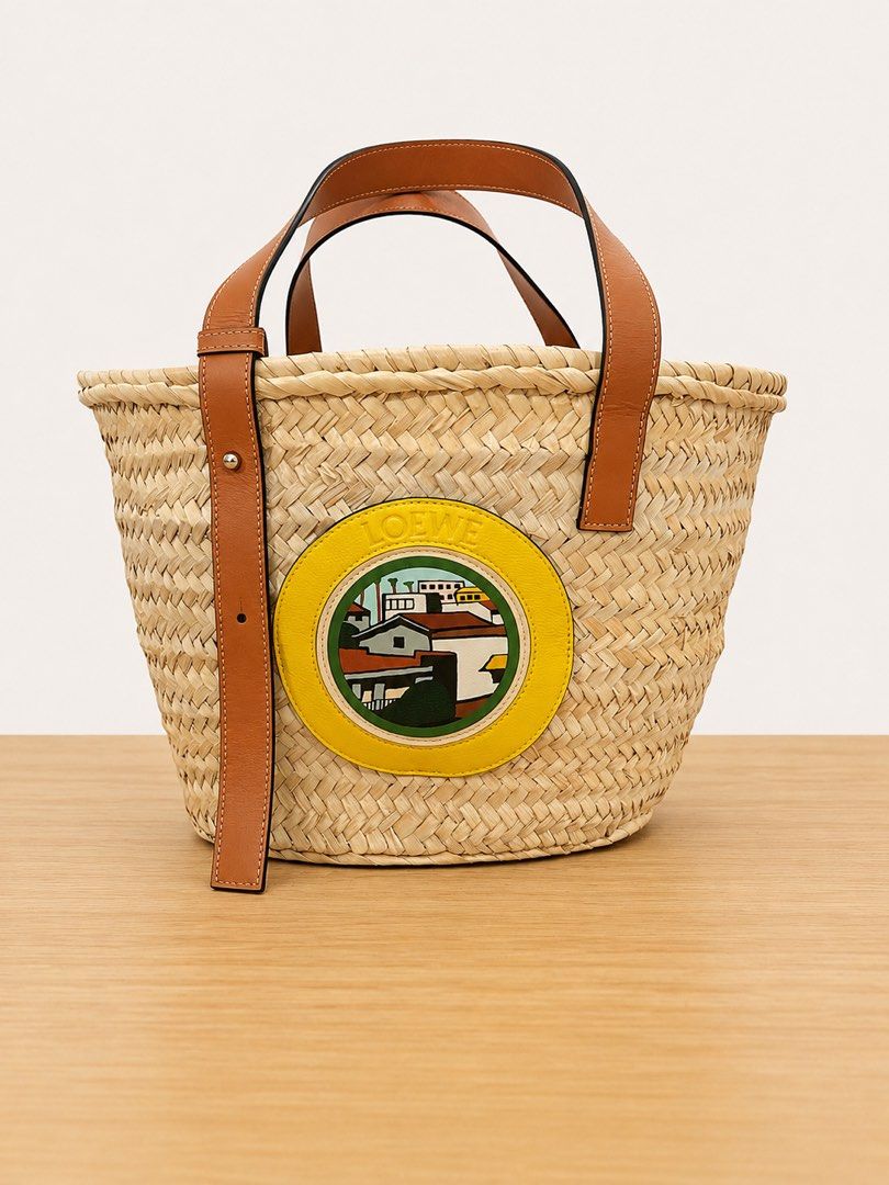 Loewe Basket Bag (Category: Luxury Bags & Wallets) located in Paranaque City. Submitted by katlouieleandicho (Listing ID 1448531314, Image 2). Description: Loewe x Ken Price L.A. Series Basket Bag Beautiful and highly collectible Loewe x Ken Price L.A. Series Basket Bag, handcrafted from natural woven palm leaf with luxurious calfskin leather handles and trim. The front features the signature Ken Price leather appliqué, making this a distinctive 