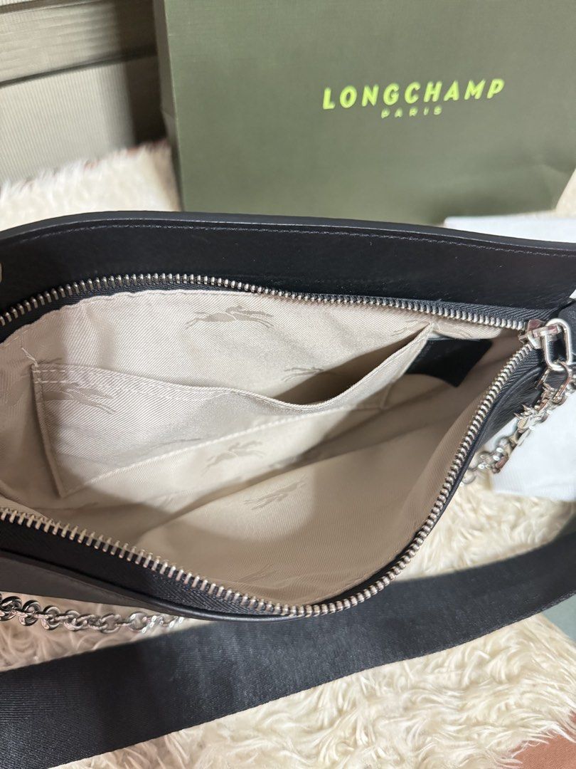 Longchamp Black Leather Crescent Shoulder Bag with Chain (Category: Luxury Bags & Wallets) located in Pasig City. Submitted by pepay_c (Listing ID 1448565452, Image 3). Description: - Authentic Longchamp black leather bag - Elegant crescent shape - Stylish silver chain detail - Signature Longchamp logo printed on strap - Convenient interior pockets - Comes with original dust bag, box, and authenticity cards - Proudly Made in France - Bought in Pa