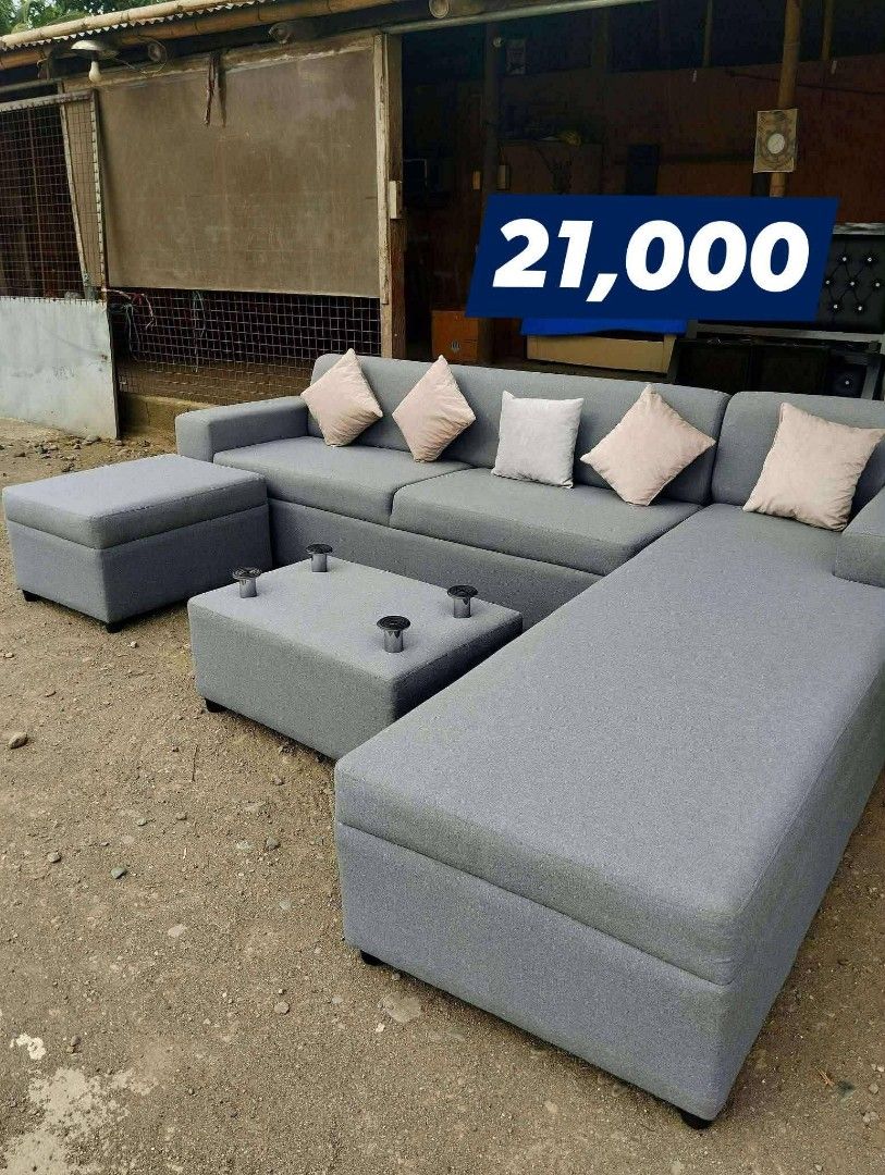 L-Shape Sofa with Storage and Coffee Table (Category: Sofas) located in Iloilo. Submitted by semicglinda (Listing ID 1448605642, Image 1). Description: - Grey L-shape sofa set - Includes coffee table with storage - Comes with two ottomans (one with storage) - Ample seating space - Ideal for living rooms - Price: PHP 21,000.