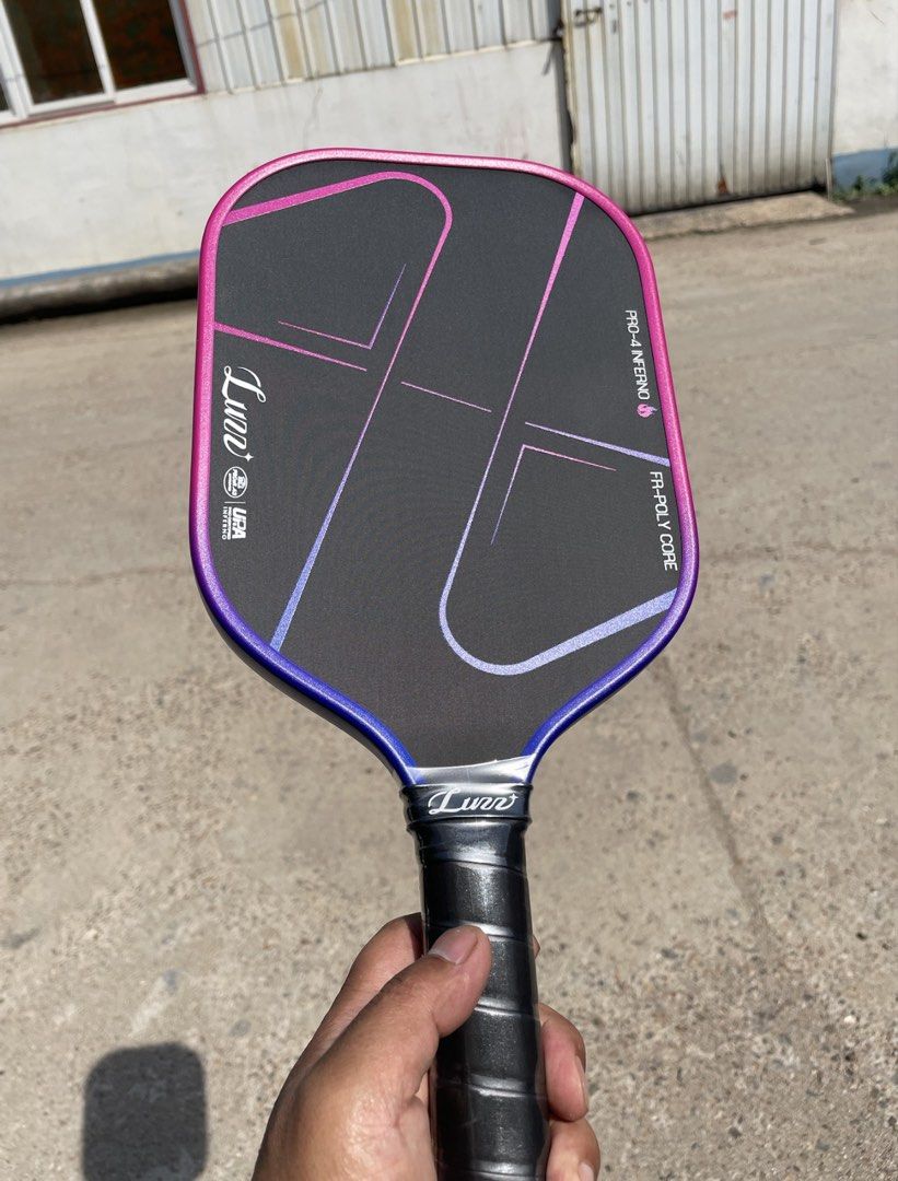 Luzz Pickleball Paddle Pro-4 Inferno FR-Poly Core (Category: Racket and Ball Sports) located in Manila. Submitted by levelup0 (Listing ID 1448488106, Image 2). Description: - Luno Pro-4 Inferno Pickleball Paddle - Eye-catching Pink and Blue Gradient Design - FR-Poly Core for enhanced play - Includes original packaging - Ideal for pickleball enthusiasts.